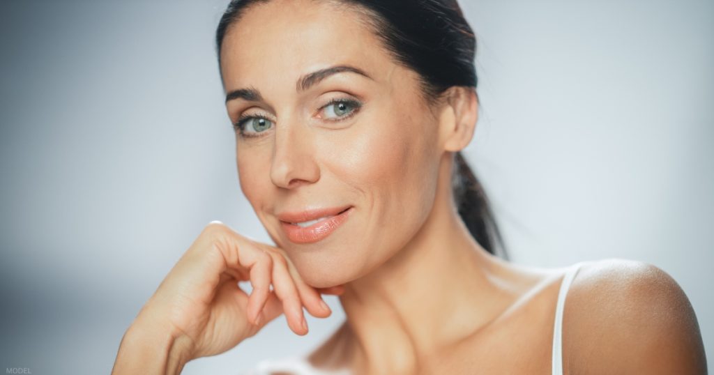 Woman smiling after a facelift procedure (model)