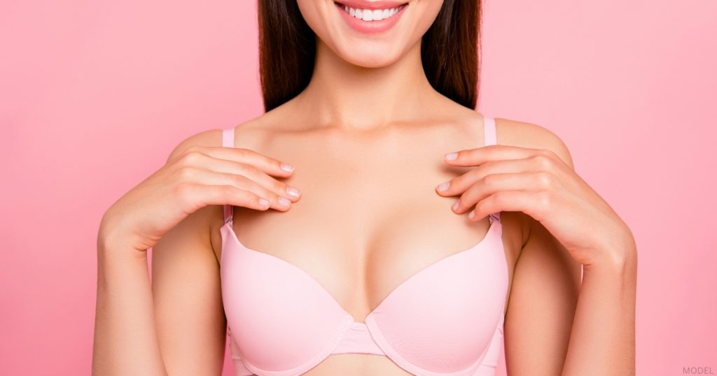 Woman showcasing breast augmentation results (model)