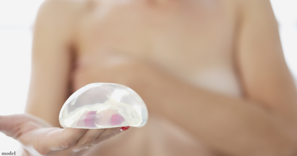 woman holding silicone breast implant