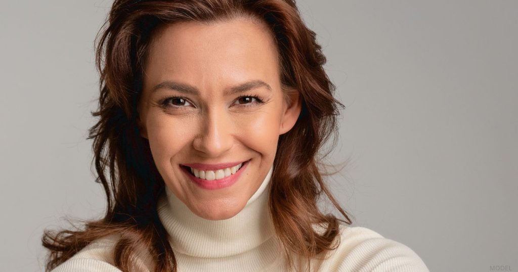 Woman smiling after her facelift (model)