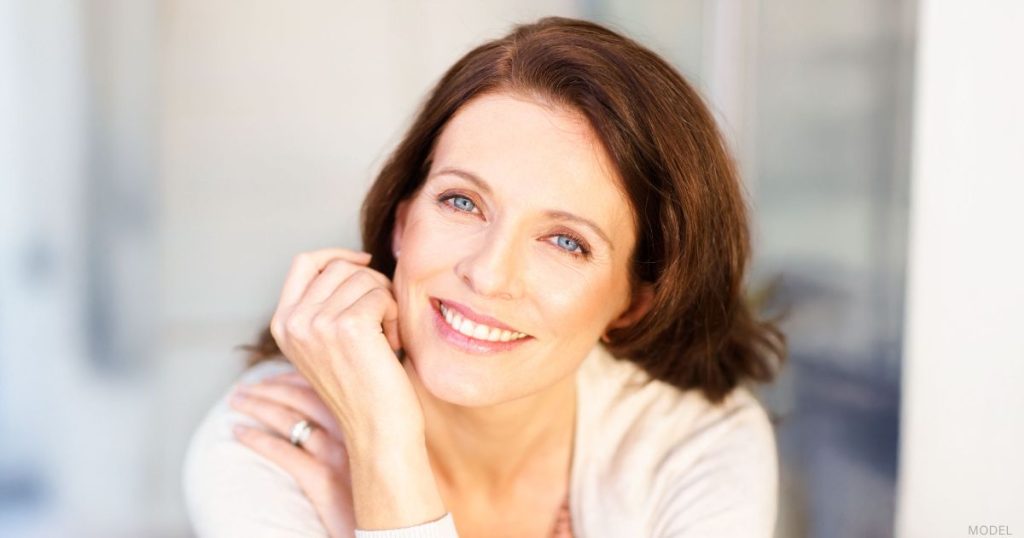 Mature woman smiling after a facelift procedure (model)